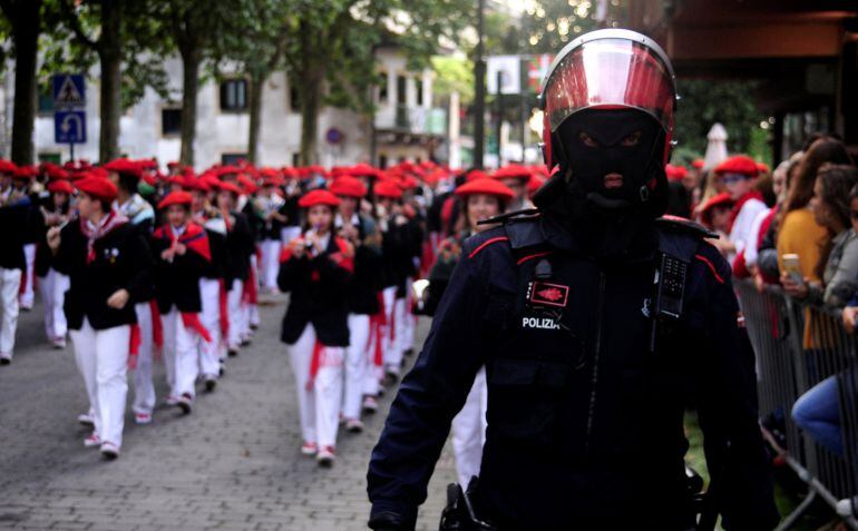 A masked policeman escorts the Jaizkibel company during the Alarde of Hondarribia, September 8, 2018. Jaizkibel has drawn criticism from traditionalists for including women in roles previosly reserved for men in the parade, which commemorates victory over