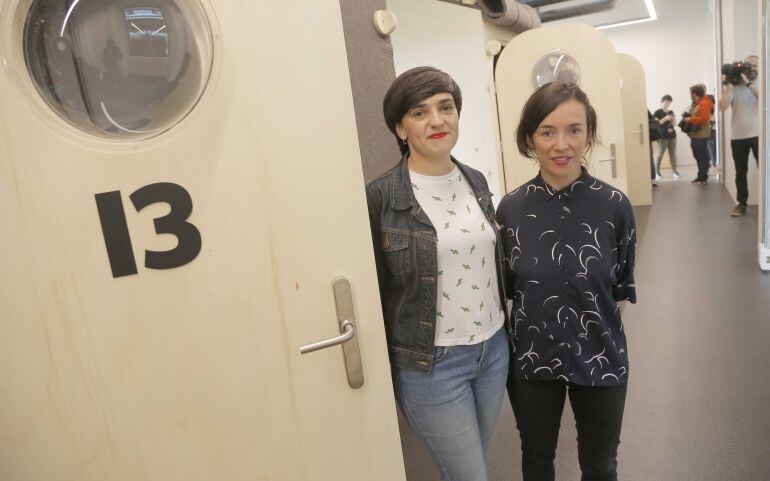 Ane Agirre, responsable de creaciones artísticas de Tabakalera, y Ane Rodríguez, directora del centro, posan junto a una de las cabinas de edición del Espacio de Creadores.