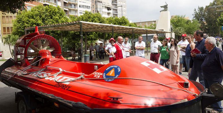 Voluntarios y visitantes atienden a las explicaciones de la labor de Cruz Roja