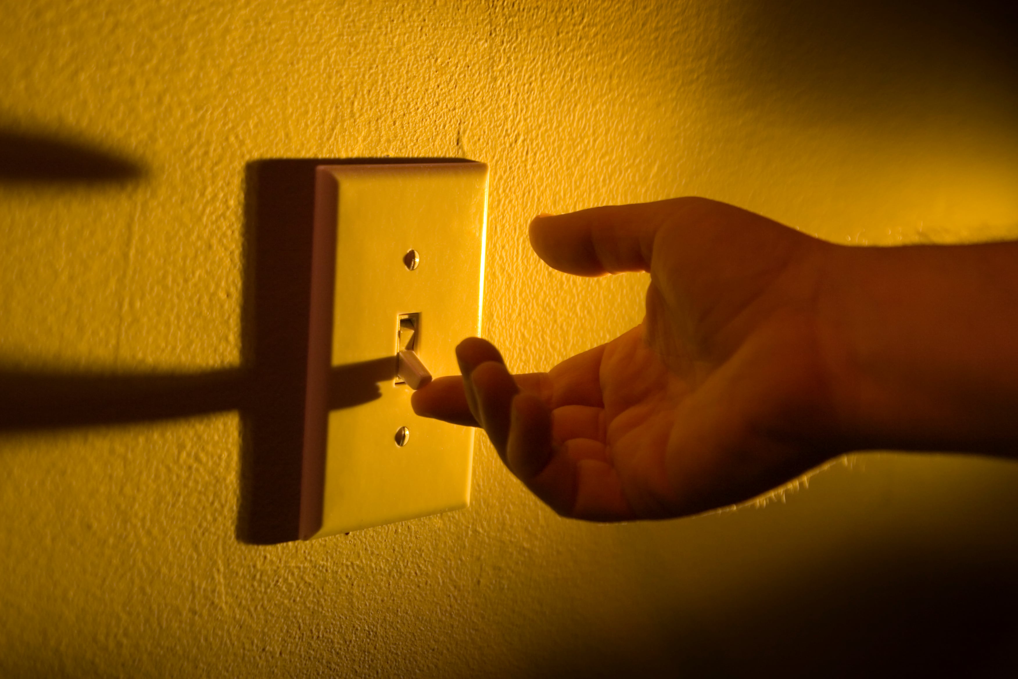 Una persona encendiendo la luz de casa.