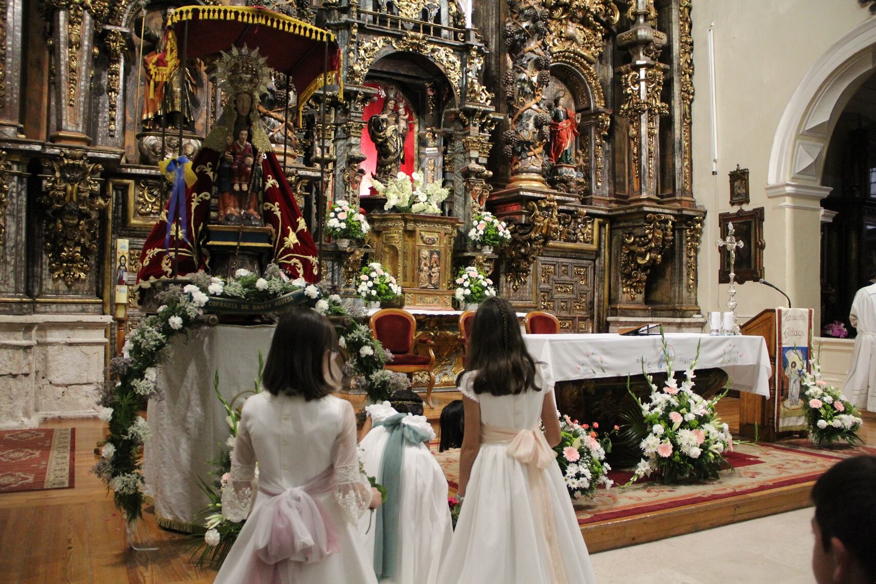 Niños que han tomado la Primera Comunión hacen una ofrenda floral a la Virgen de El Henar