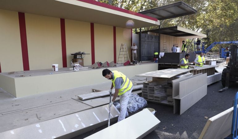 Un grupo de operarios trabajan en las tribunas que se estan instalando en el Paseo de Recolestos por donde transcurrirá la parada militar con motivo de la celebración del Dia de la Fiesta Nacional el próximo 12 de Octubre. 