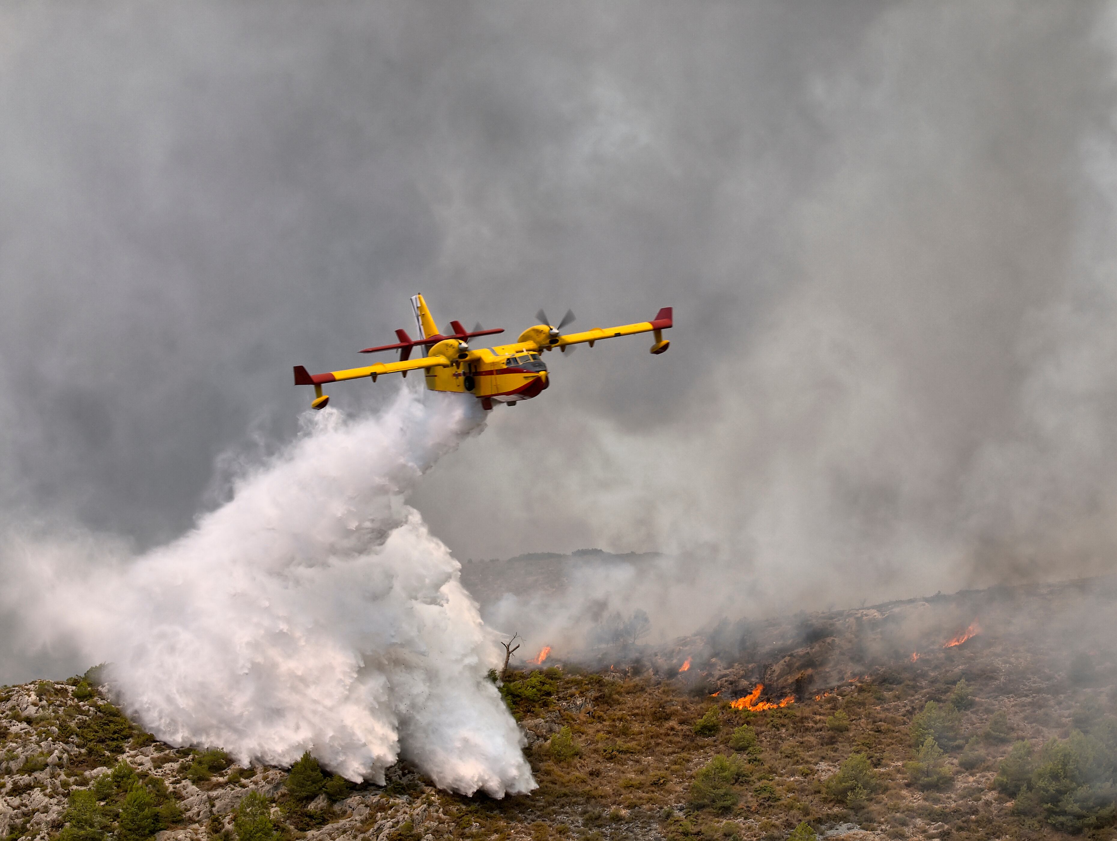 Firefighting seaplane working on a fire in the city of Beneixama in the province of Alicante, Spain.