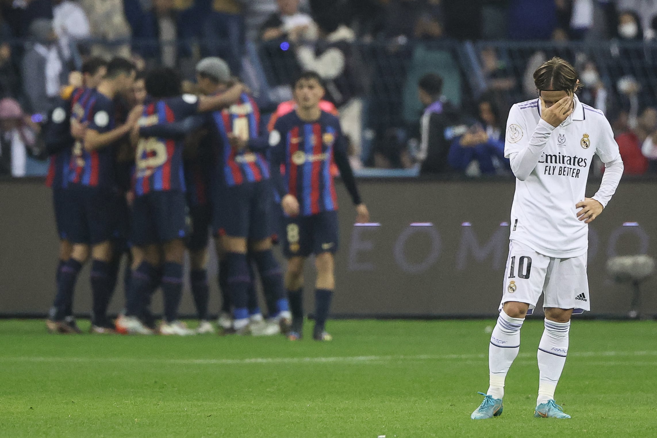 Modric se lamenta mientras los jugadores del Barça celebran un gol en la pasada Supercopa de España.