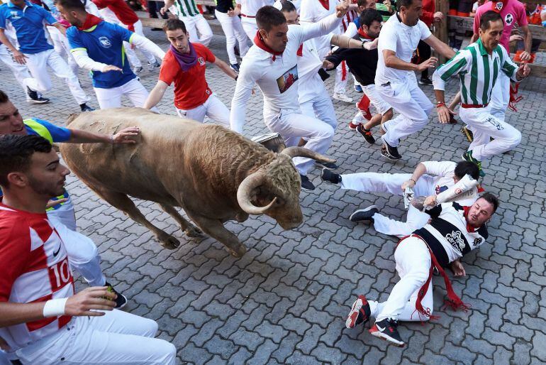 Un toro de la ganadería gaditana de Núñez del Cuvillo a su paso por el tramo de Telefónica durante el quinto encierro de los Sanfermines 2018