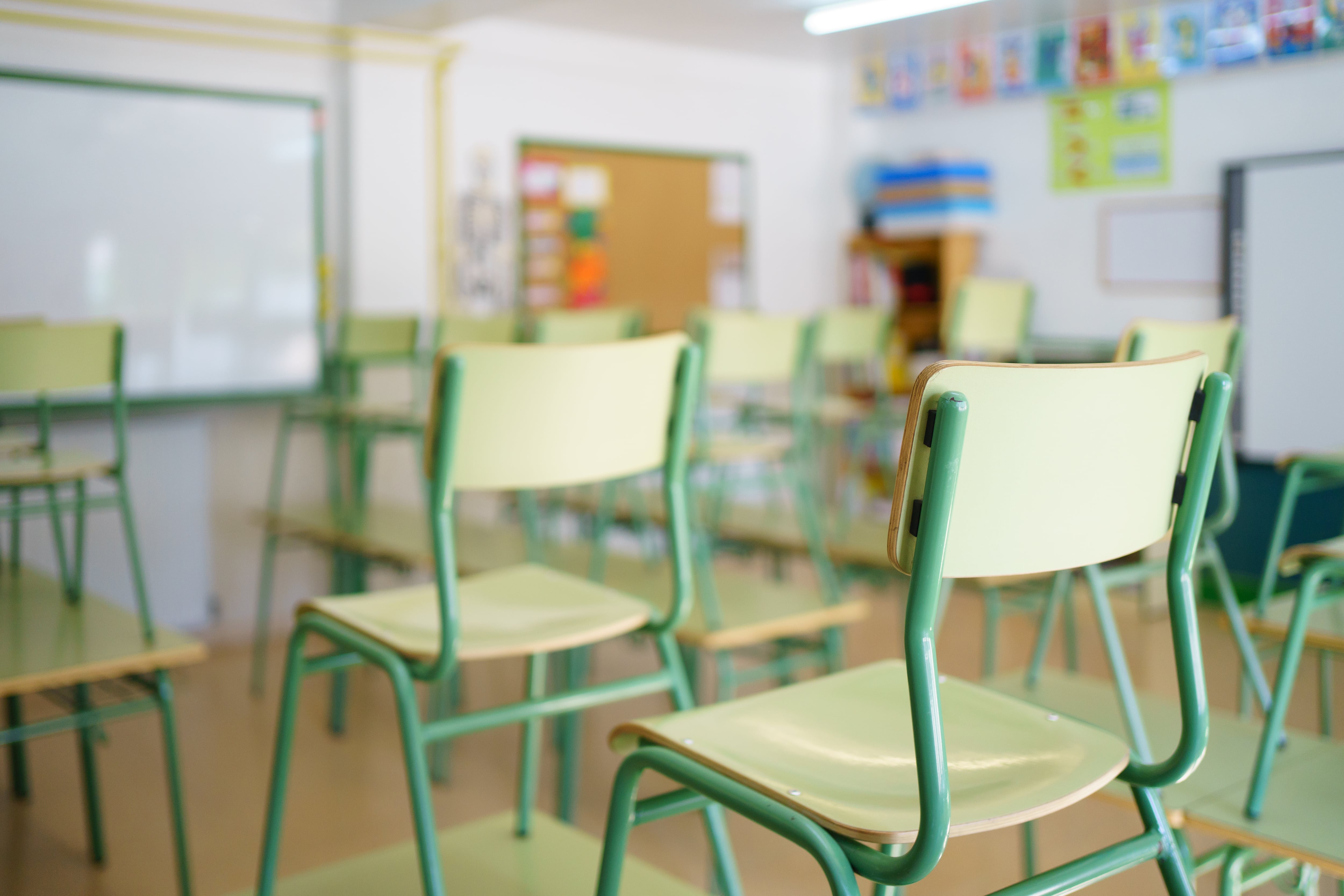 Close-up of a chair on a student&#039;s desk inside a classroom in a secondary school.