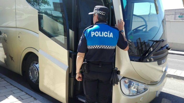 Un agente de la Policía Local accede a un autobús de transporte escolar