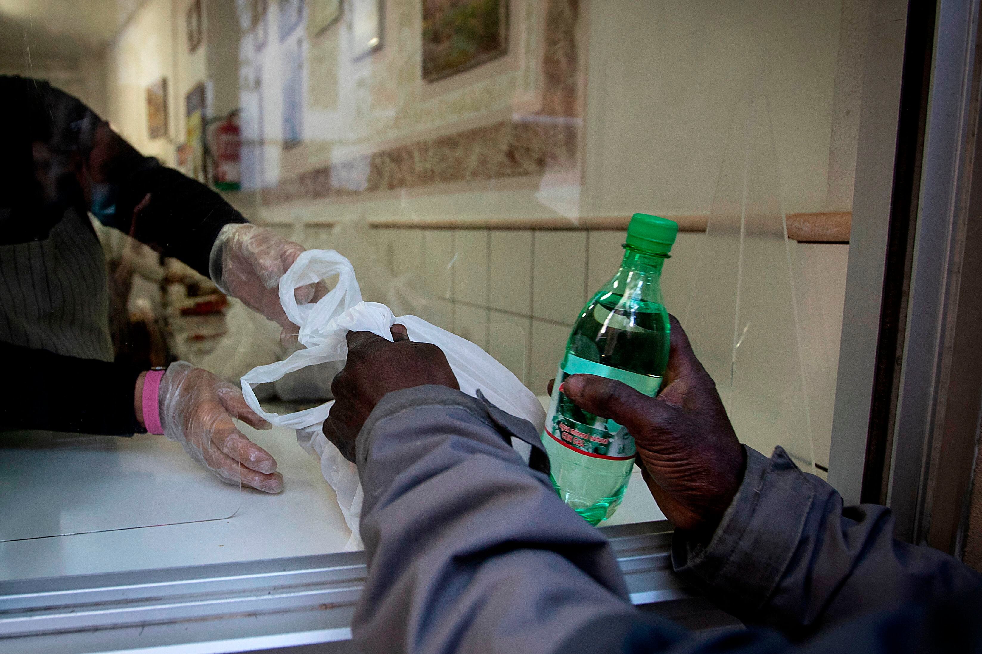 A man receives his ration of food aid at the Zaqueo Association in Palma de Mallorca on December 2, 2020. (Photo by JAIME REINA / AFP) (Photo by JAIME REINA/AFP via Getty Images)