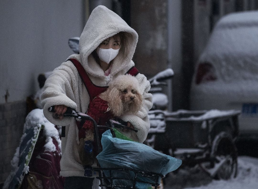 Una mujer china, con máscara.