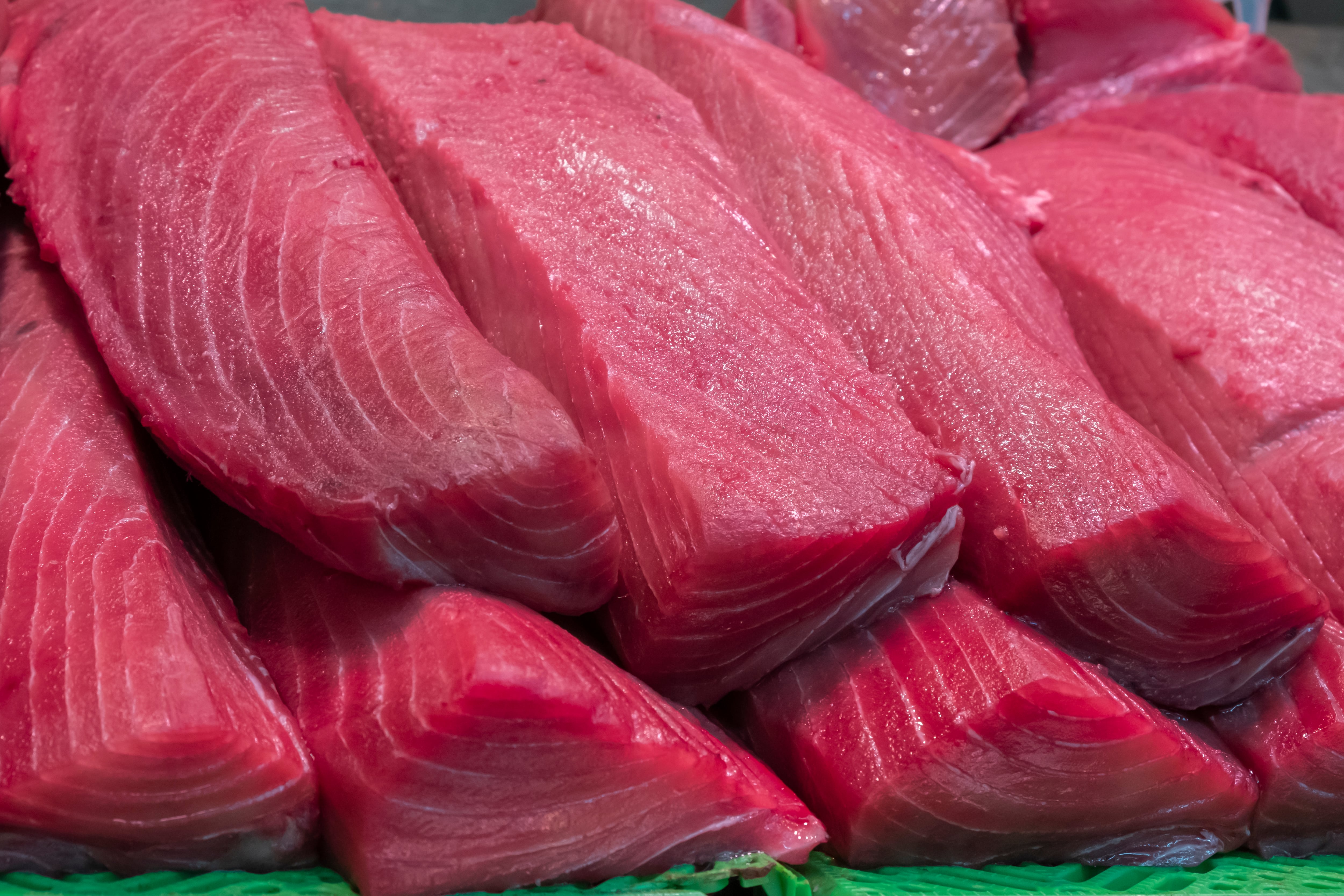 Pieces of freshly caught and chopped bluefin tuna for sale in a traditional market on the Spanish coast.