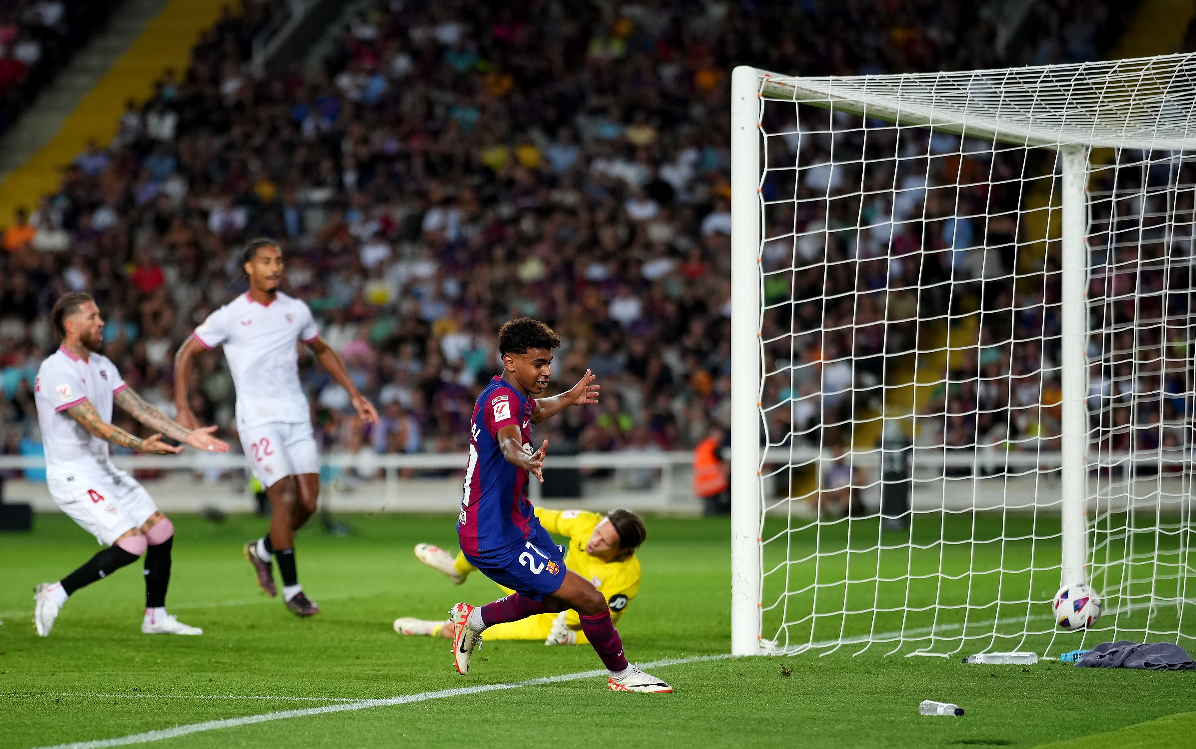BARCELONA, SPAIN - SEPTEMBER 29: Lamine Yamal of Barcelona celebrates as Sergio Ramos of Sevilla scores an own-goal during the LaLiga EA Sports match between FC Barcelona and Sevilla FC at Estadi Olimpic Lluis Companys on September 29, 2023 in Barcelona, Spain. (Photo by Alex Caparros/Getty Images)