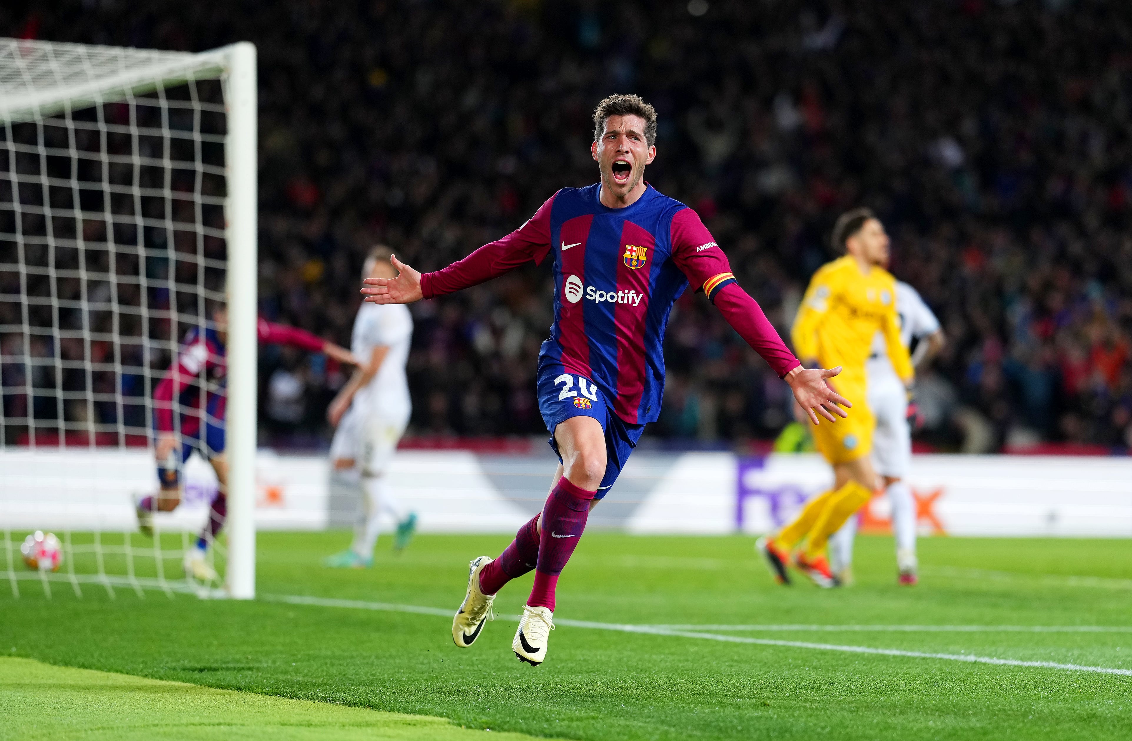 BARCELONA, SPAIN - MARCH 12: Sergi Roberto of FC Barcelona celebrates after Robert Lewandowski of FC Barcelona (not pictured) scores his team&#039;s third goal during the UEFA Champions League 2023/24 round of 16 second leg match between FC Barcelona and SSC Napoli at Estadi Olimpic Lluis Companys on March 12, 2024 in Barcelona, Spain. (Photo by Alex Caparros/Getty Images)