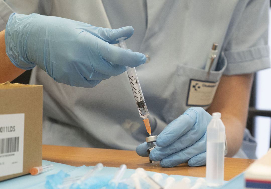 Una enfermera prepara una dosis de vacuna.