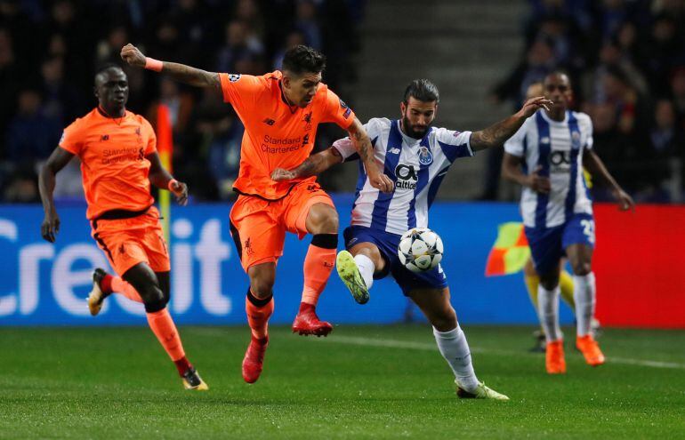 Firmino y Oliveira luchan por un balón