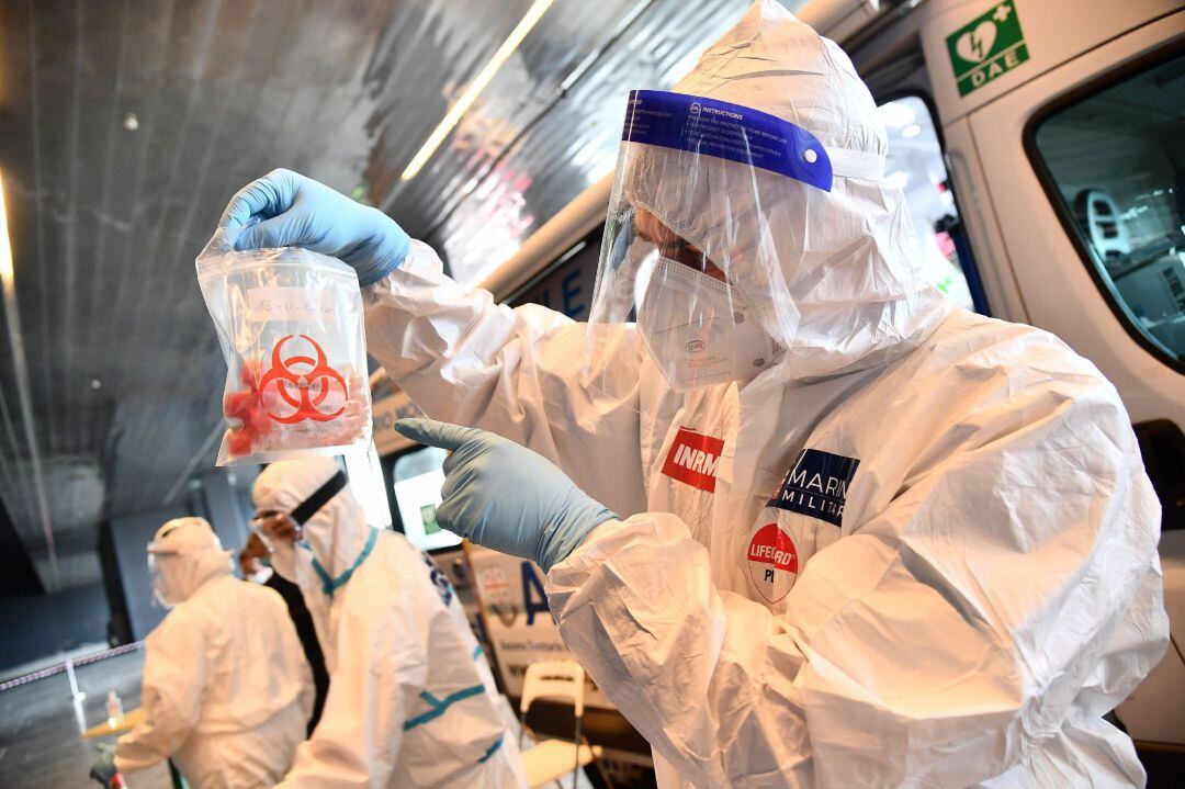 A health worker collects swab samples for a polymerase chain reaction (PCR)