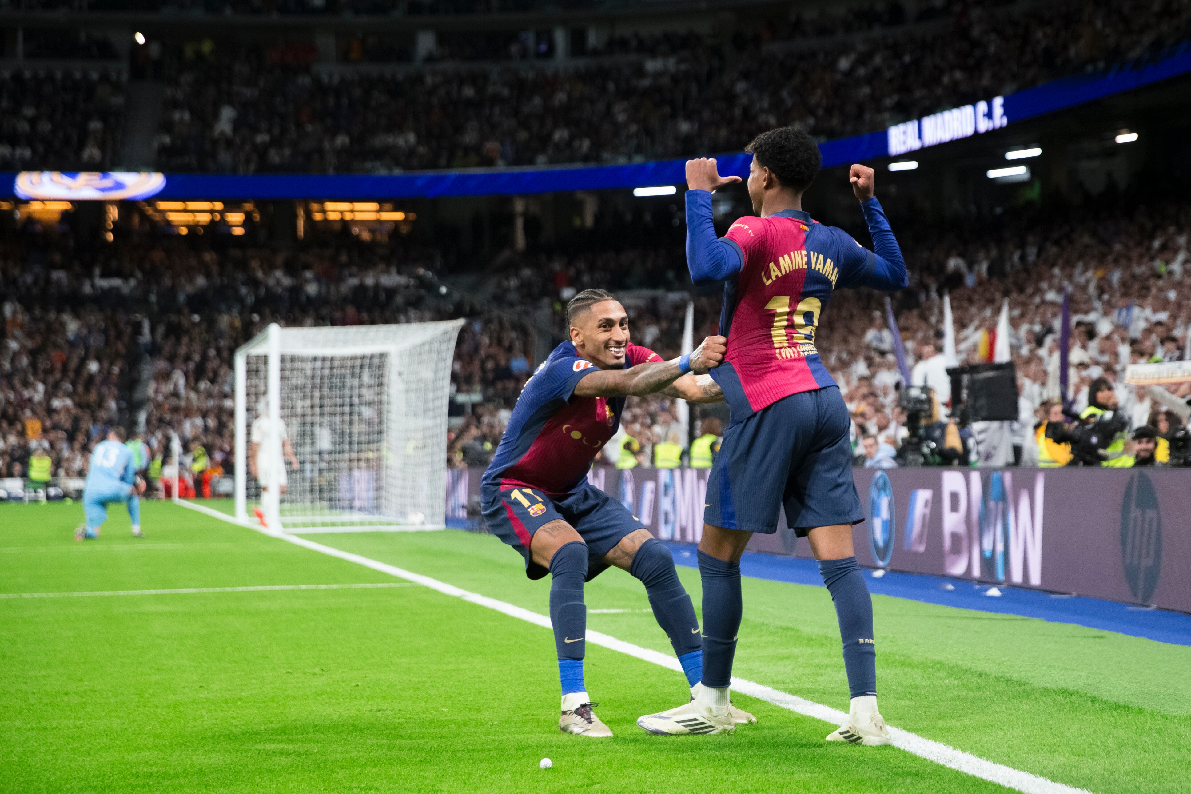 Lamine Yamal of Barcelona and Raphinha Dias of Barcelona celebrate a goal during the La Liga 2024/25 match between Real Madrid and F.C. Barcelona at Santiago Bernabeu Stadium in Madrid, Spain, on October 26. (Photo by Guillermo Martinez)