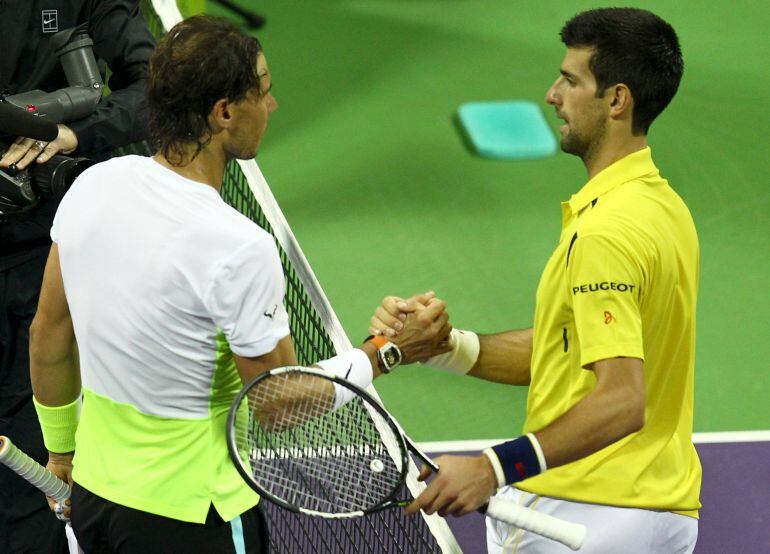  Novak Djokovic of Serbia (R) shakes hands with Rafael Nadal of Spain after their Qatar Open men's single tennis final match in Doha, Qatar January 9, 2016.   REUTERS/Ibraheem Al Omari