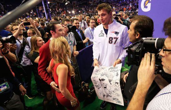 PHOENIX, AZ - JANUARY 27: Rob Gronkowski #87 of the New England Patriots walks with Johnny Weir and Tara Lipinski of NBC at Super Bowl XLIX Media Day Fueled by Gatorade inside U.S. Airways Center on January 27, 2015 in Phoenix, Arizona. Rob Carr/Getty Ima