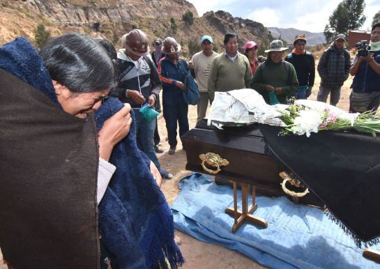 Familiares y mineros velan en una carretera de la región central de Cochabamba el cuerpo de Fermín Mamani