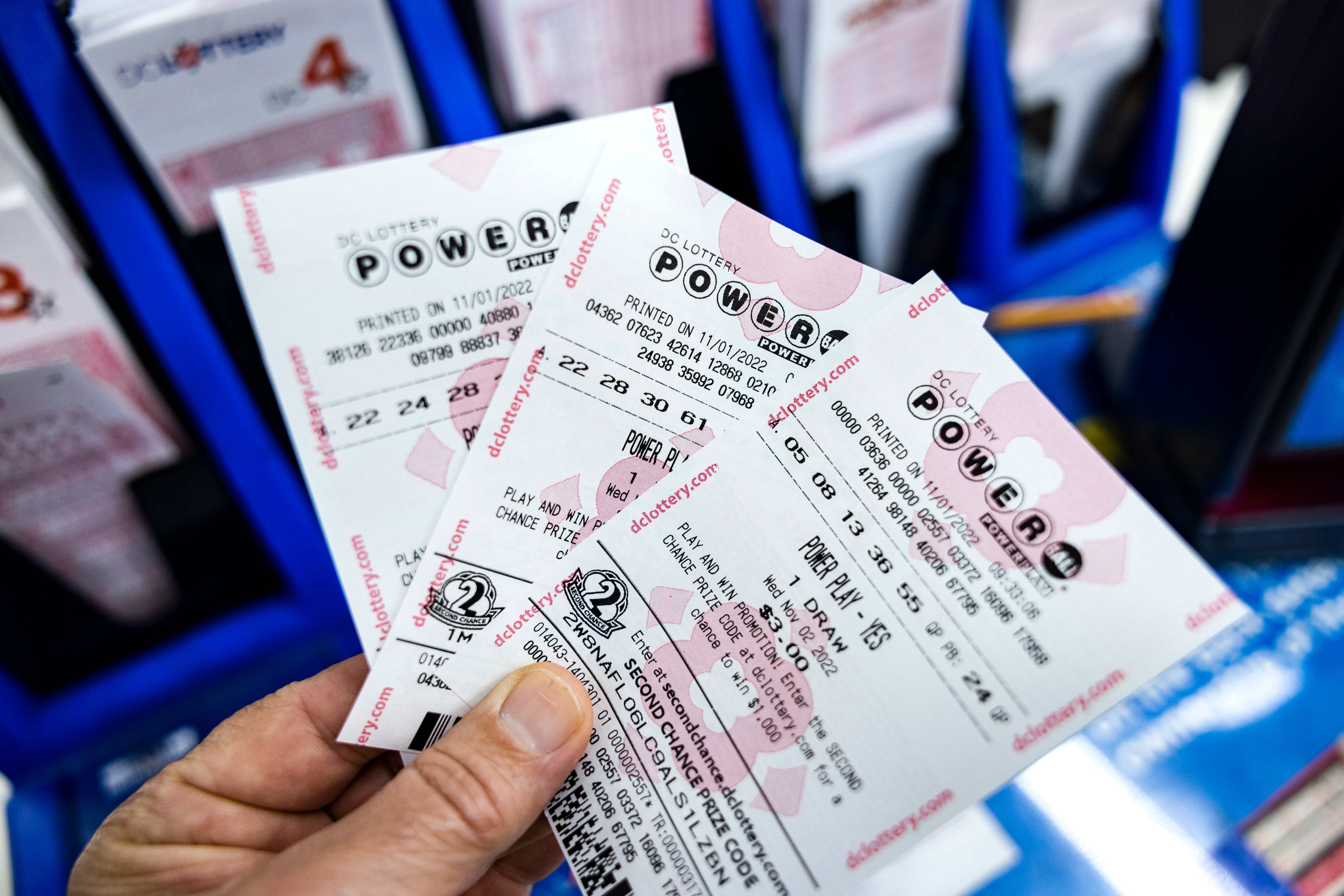 Una persona muestra tickets de la lotería Powerball en Estados Unidos