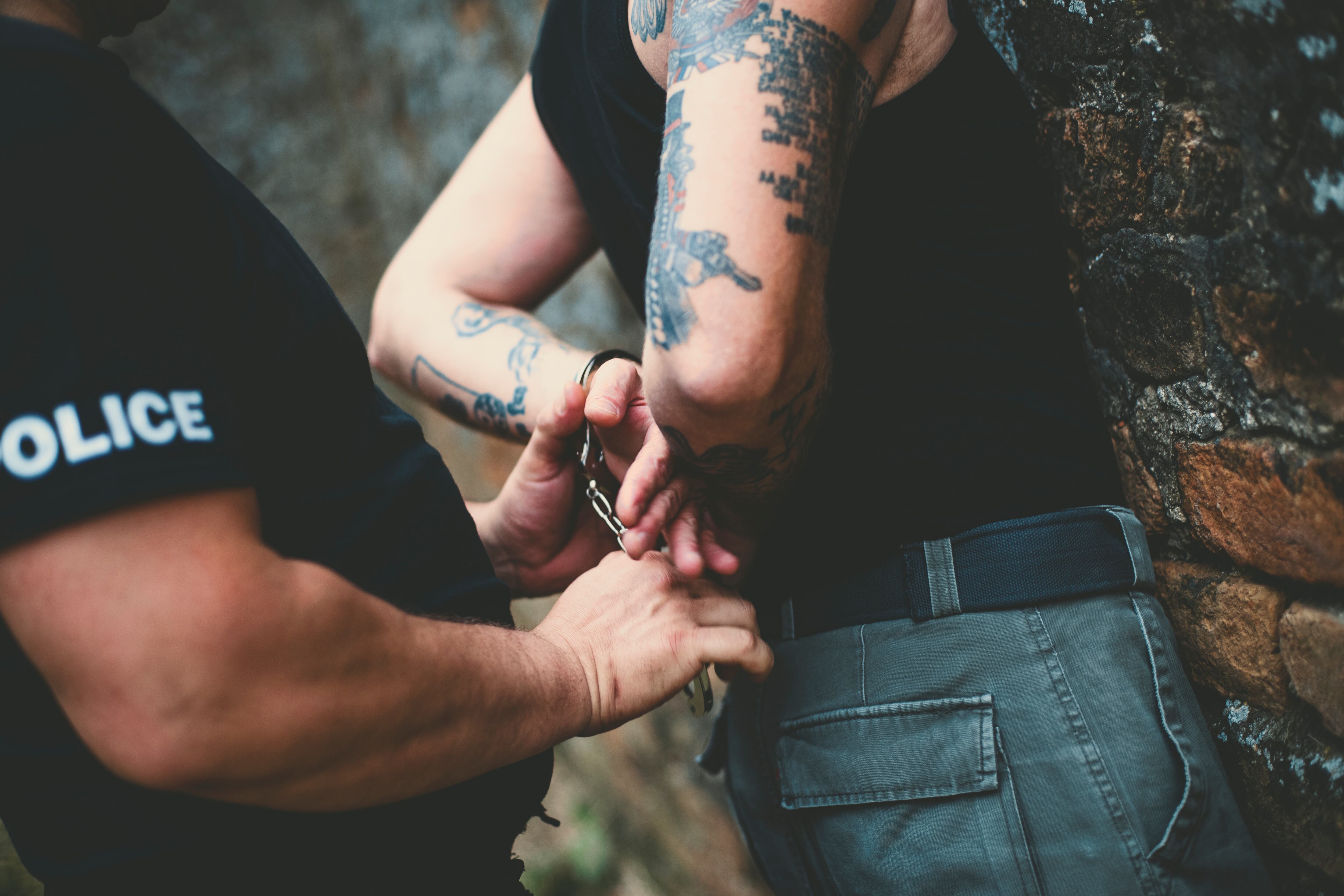 Police putting handcuffs on a man