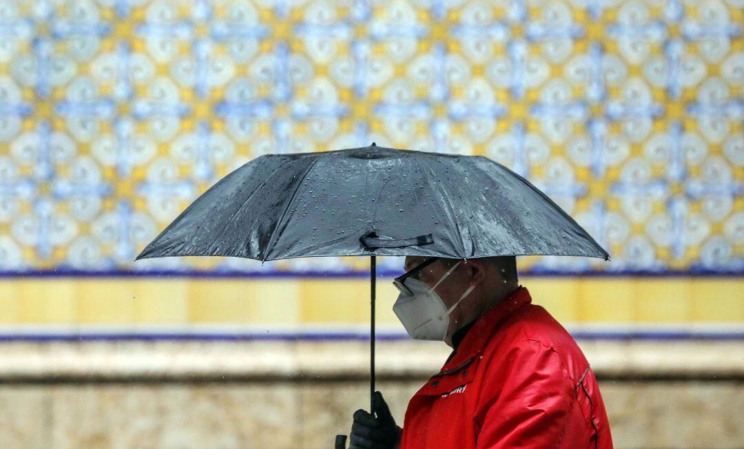 Un hombre se protege con un paraguas de la lluvia durante este 15 de abril, el trigésimo segundo día del estado de alarma.