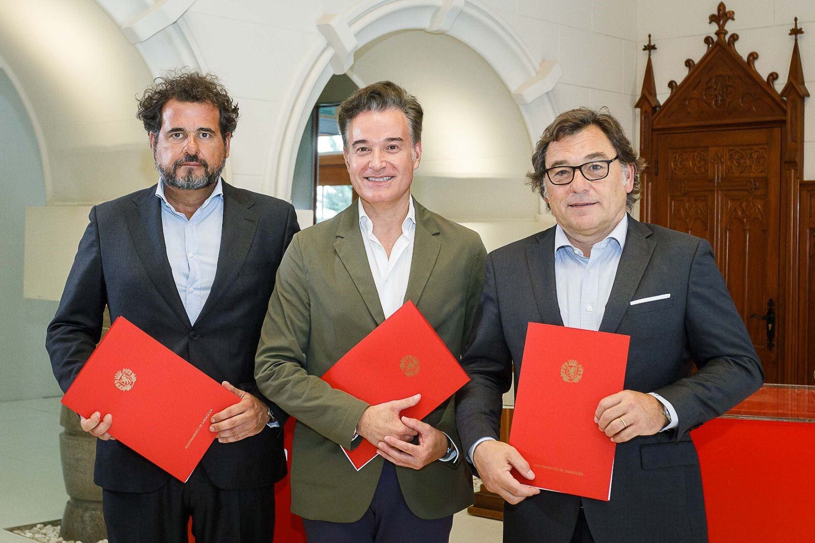 Raúl Sanllehí,, a la izquierda, junto al concejal, Víctor Serrano, y al director financiero, Mariano Aured, durante la firma del convenio para las mejoras en la Romareda
