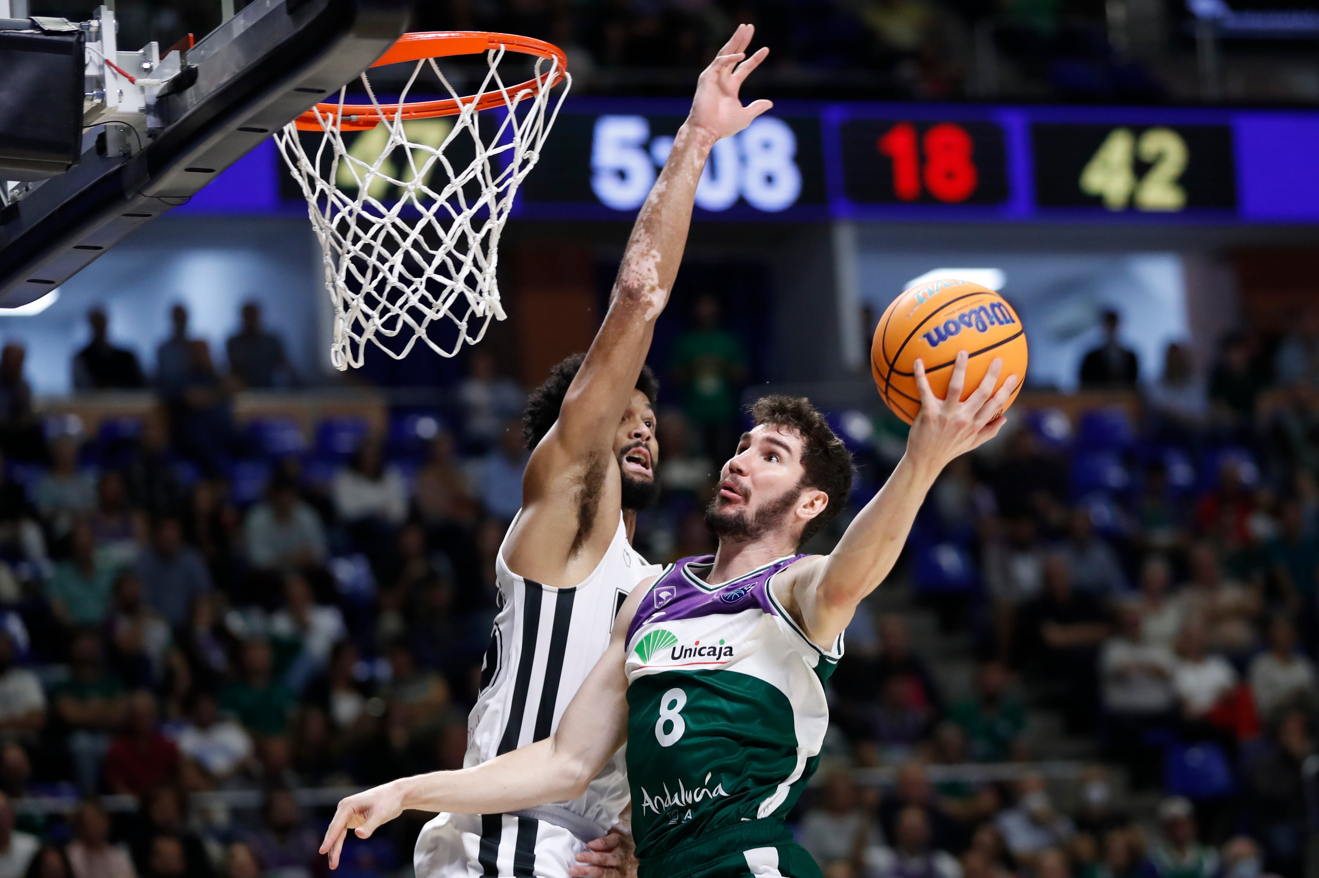 El escolta español del Unicaja Darío Brizuela (d) entra a canasta ante la defensa de Nate Renfro (i), alero estadounidense del PAOK Salónica, durante el partido de la Liga de Campeones de baloncesto entre Unicaja Málaga y PAOK Salónica, este miércoles en el Palacio de Deportes José María Martín Carpena de Málaga. EFE/ Jorge Zapata