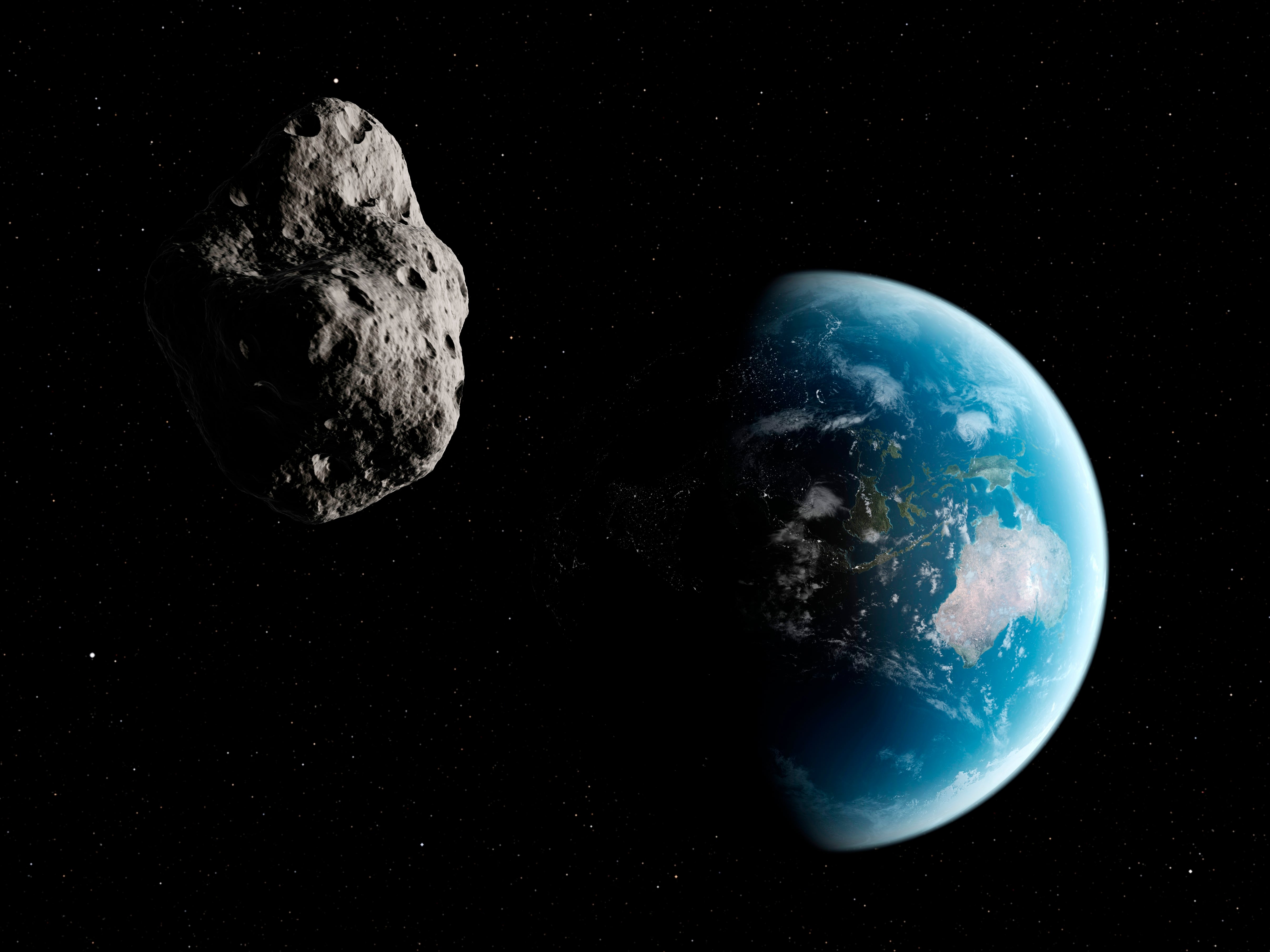 Recreación de un asteroide con el planeta Tierra de fondo