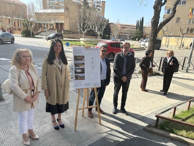 representantes del Ayuntamiento, del barrio de Santiago y el arquitecto Ignacio Lacarte frente a la fuente de la plaza Luis Buñuel de Huesca