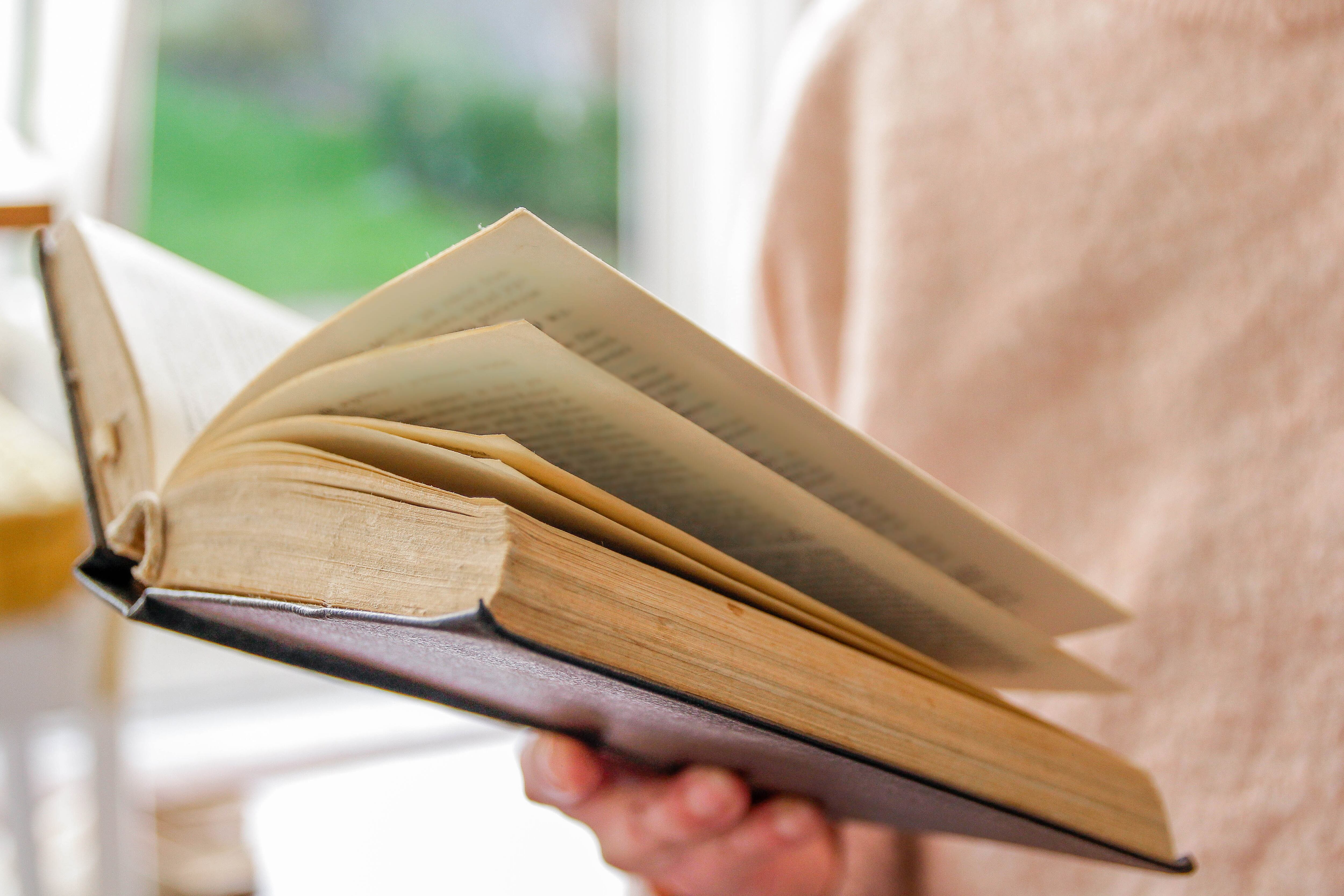 Praying, reading a book