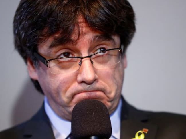 Carles Puigdemont reacts during a news conference in Berlin,