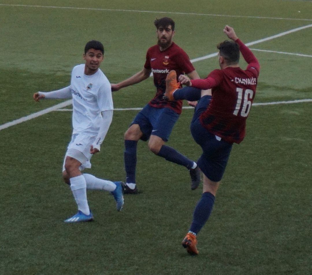 Juanjo Chavalés disputa un balón en presencia de Víctor Oliver