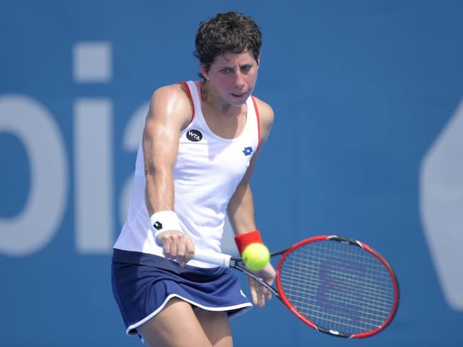SYDNEY, AUSTRALIA - JANUARY 13: Carla Suarez Navarro of Spain plays a backhand shot in her second round match against Ekaterina Makarova of Russia during day three of the Sydney International at Sydney Olympic Park Tennis Centre on January 13, 2015 in Sydney, Australia. (Photo by Brett Hemmings/Getty Images)