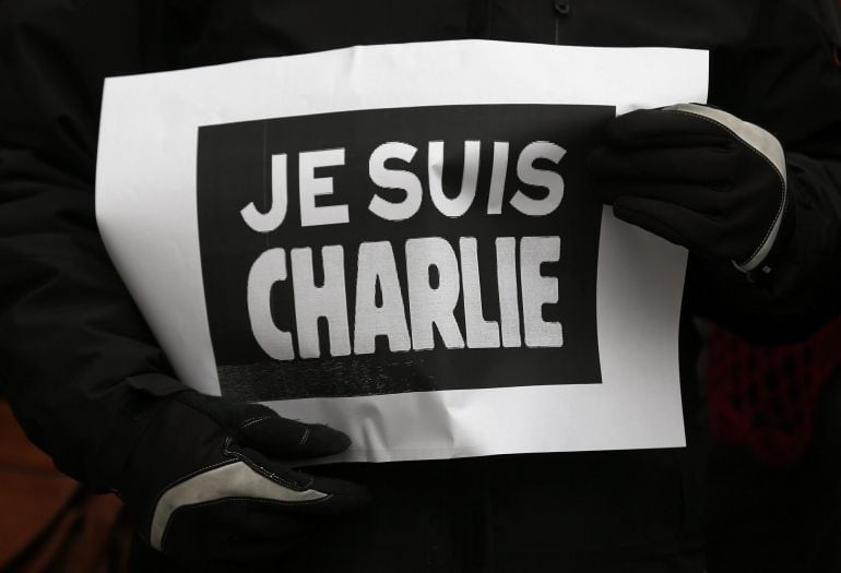 A person holds a placard which reads &quot;I am Charlie&quot; during a minute of silence in Strasbourg January 8, 2015 for victims of the shooting at the Paris offices of weekly satirical newspaper Charlie Hebdo on Wednesday. French police extended a manhunt on Thu