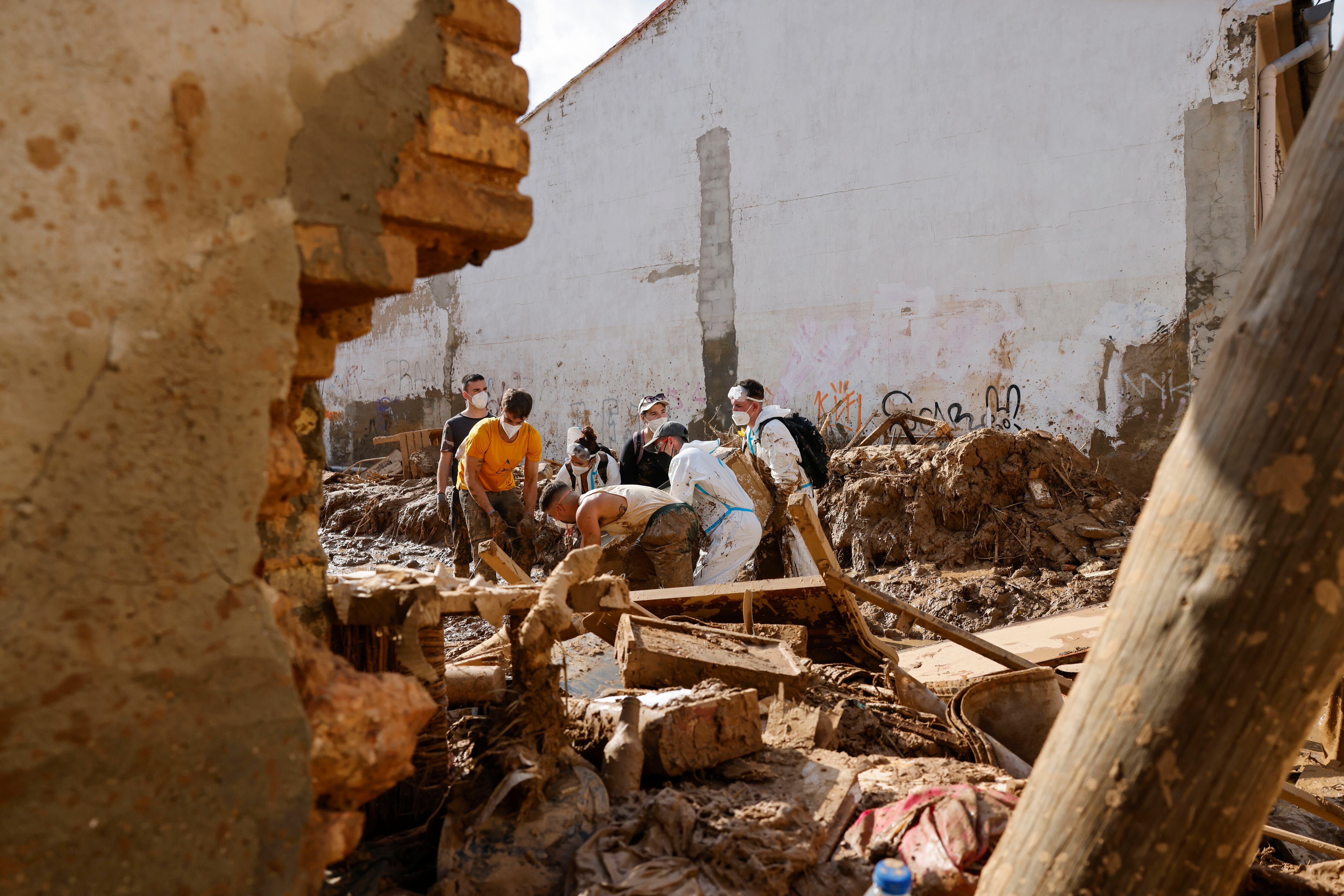 MASANASA (VALENCIA), 07/11/2024.- Voluntarios trabajan en la limpieza y desescombro de una calle de Masanasa, Valencia.