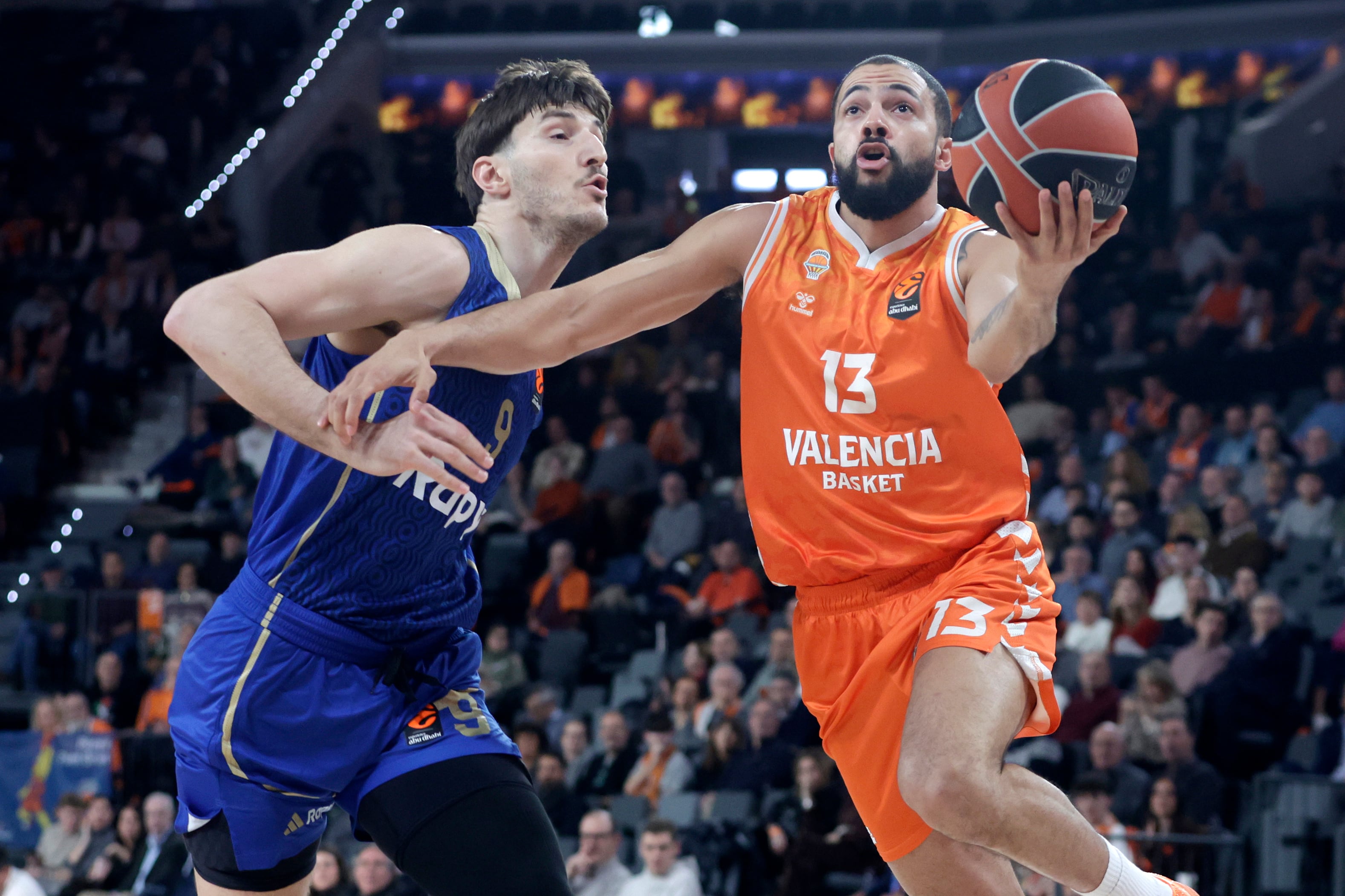 VALENCIA, 29/01/2026.- El base estadounidense con pasaporte italiano del Valencia Basket, Darius Thompson (d) supera al pívot del Maccabi Tel Aviv Roman Sorkin, durante el partido de la jornada 25 de la Euroliga de baloncesto entre el Valencia Basket y el Maccabi Tel Aviv, este jueves en el Roig Arena de Valencia. EFE/Miguel Ángel Polo.