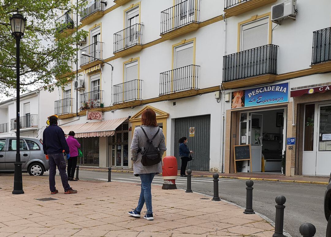 Imagen de archivo. Varios ciudadanos esperan su turno en un comercio local en el barrio de San Cristóbal