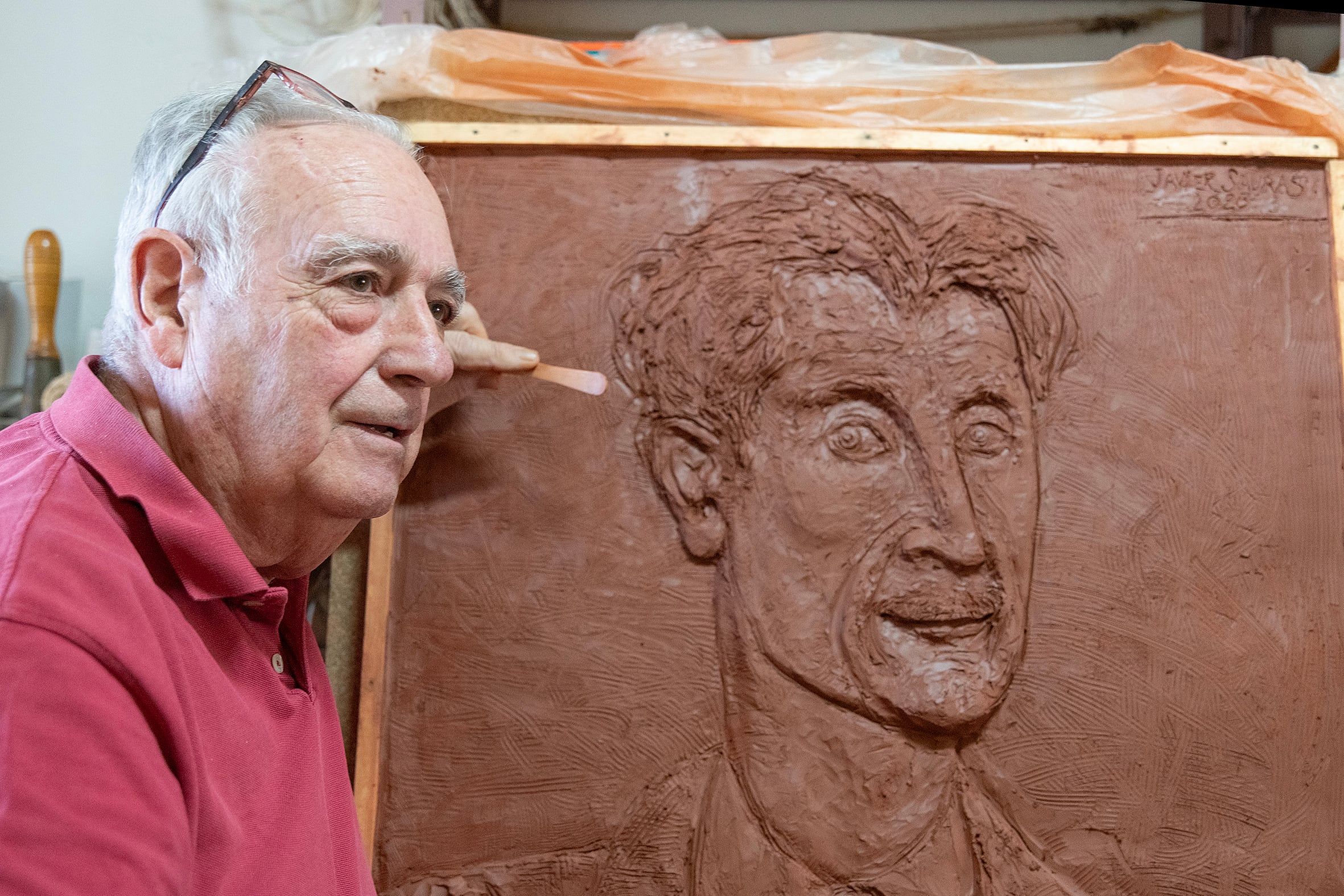 Javier Sauras en su taller, con la obra realizada en barro. (Foto Beatriz López)