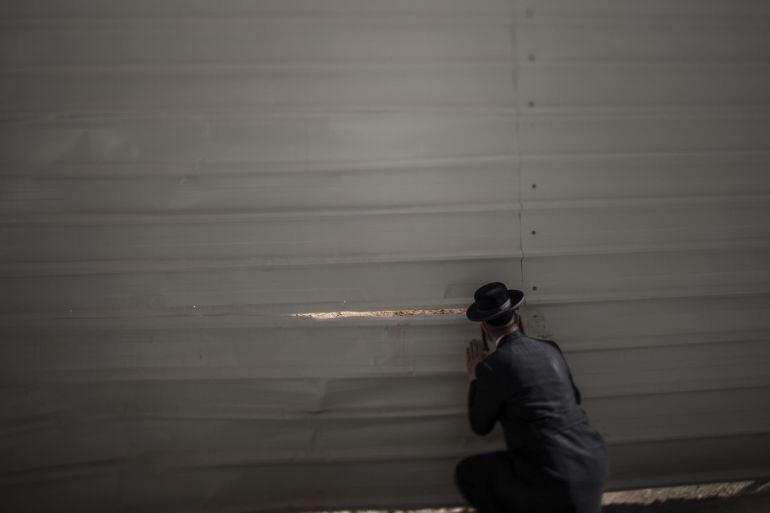 JERUSALEM, ISRAEL - DECEMBER 10: (EDITORS NOTE: This image was created using a tilt shift lens) Israeli Orthodox jews seen looking at the construction site on December 10, 2014 in Jerusalem, Israel. Orthodox jews are protesting the building of a new neigh