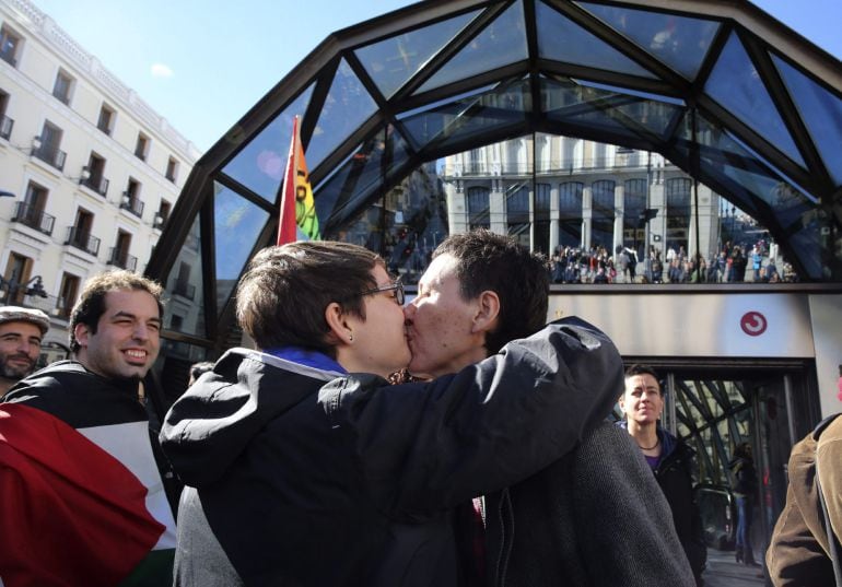 GRA188. MADRID, 22/02/2015.- Asistentes a la &quot;besada&quot; convocada por el colectivo de Lesbianas, Gais, Transexuales y Bisexuales de Madrid (COGAM) junto a la estación de metro de Sol, para denunciar la homofobia tras la circular de un trabajador de Metro de Madrid en la que instaba a incrementar la revisión de billetes a homosexuales. EFE/Alberto Martin