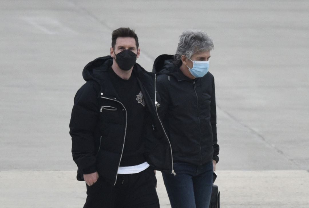 Leo Messi y su padre, Jorge Messi en un aeropuerto