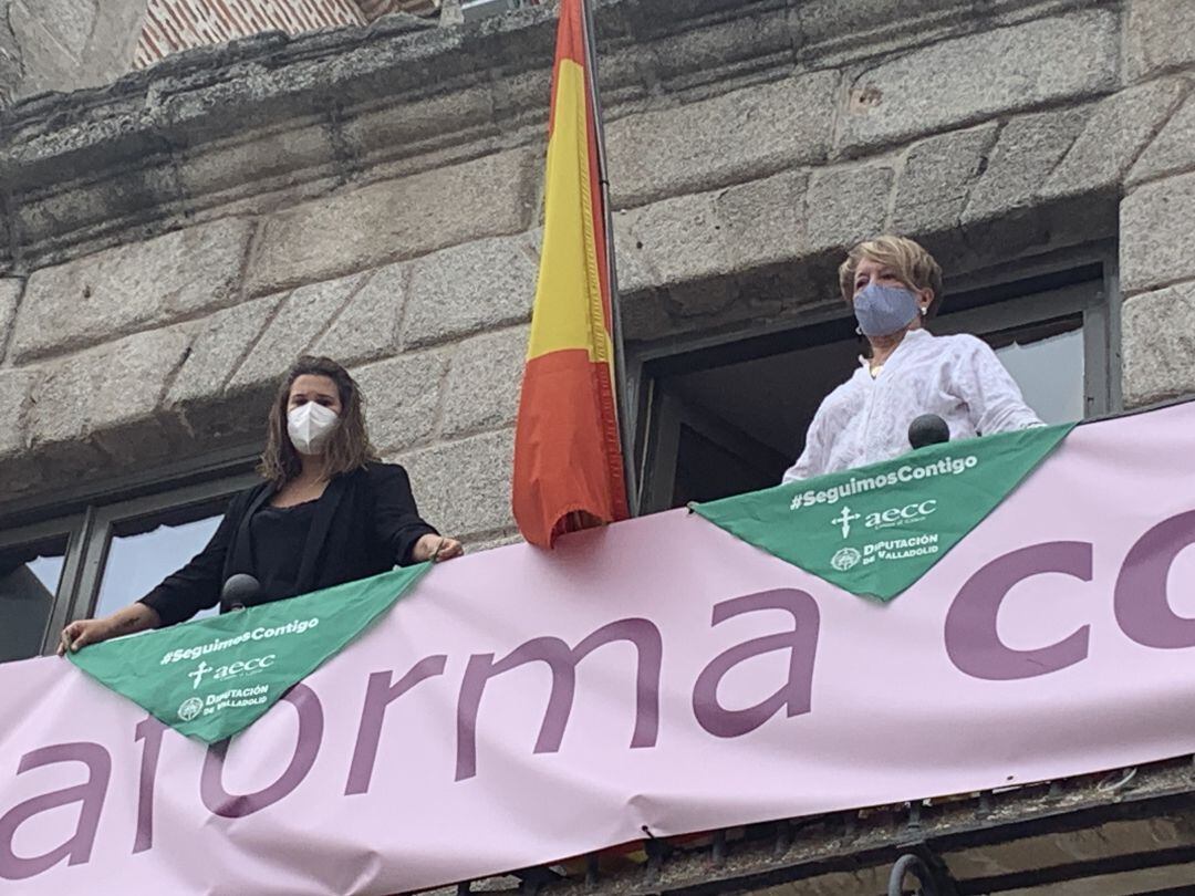 La edil de Servicios Sociales y la preseidenta de la Asociación Contra el Cáncer colocan pañoletas en el Ayuntamiento