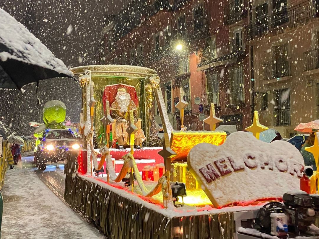 El Rey Melchor saluda entre la nieve al público de la última cabalgata