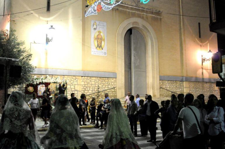 Las falleras pasan por delante de la Iglesia de Santa Ana cerrada al público 