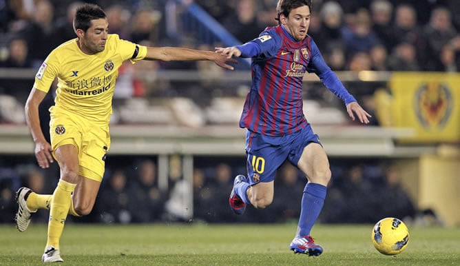 El delantero argentino del F.C. Barcelona Lionel Messi conduce el balón presionado por el mediocentro del Villarreal C.F. Bruno Soriano durante el partido, correspondiente a la vigésimo primera jornada del Campeonato Nacional de Liga de Primera División