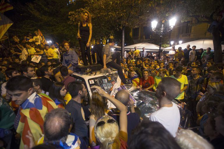 Manifestantes sobre un coche de la Guardia Civil. 