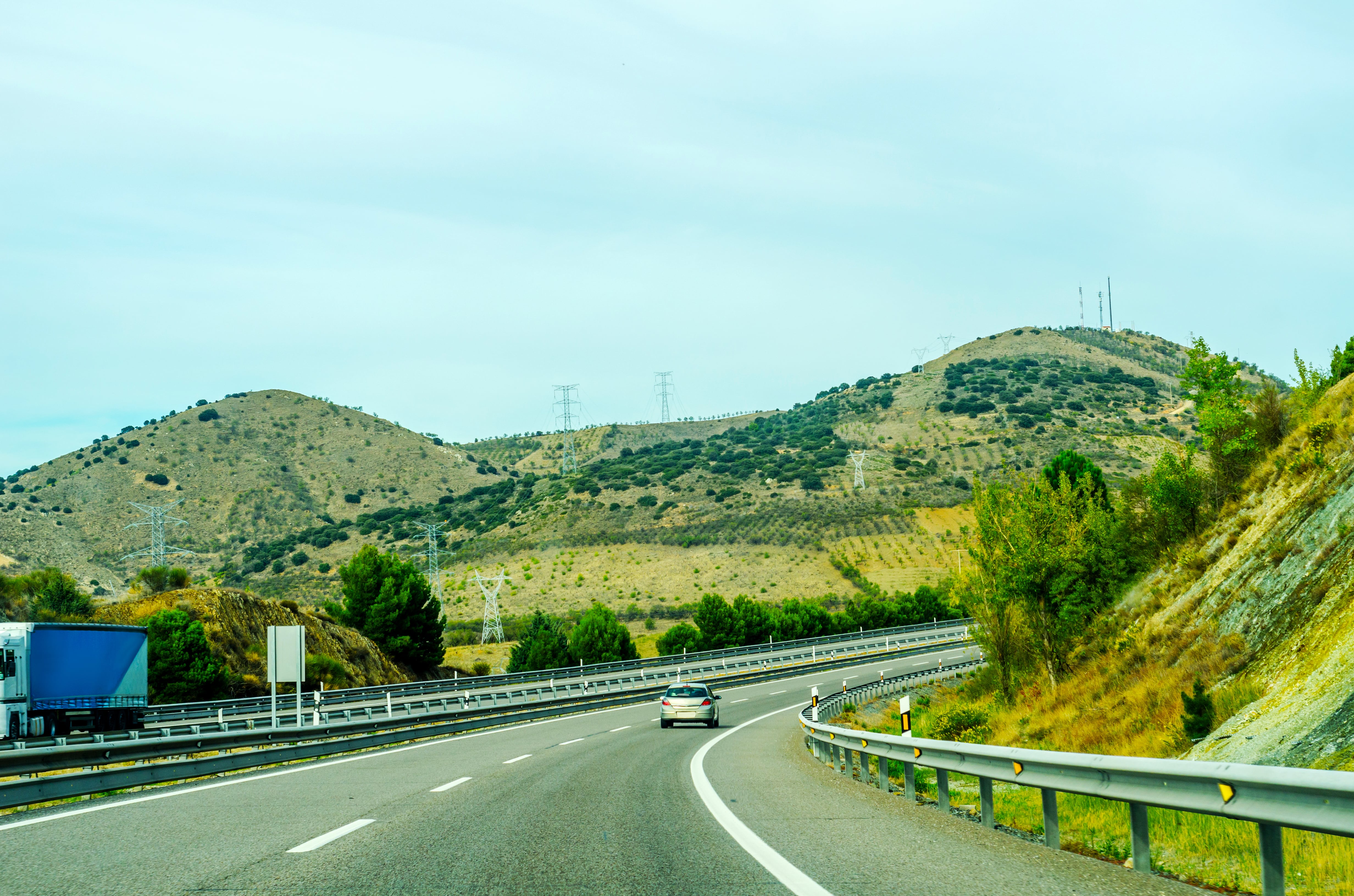 Fast road in the mountains in Spain, beautiful landscape of mountains, dry earth and rock from the sun, transportation