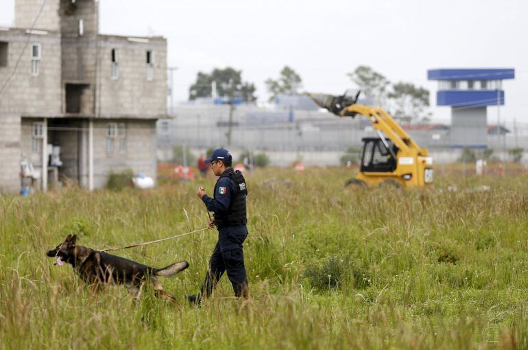 A police patrols with dogs near Altiplano Federal Penitentiary, where drug lord Joaquin &quot;El Chapo&quot; Guzman escaped from, in Almoloya de Juarez, on the outskirts of Mexico City, July 14 , 2015. Mexican authorities must have colluded with Joaquin &quot;El Chapo&quot; 