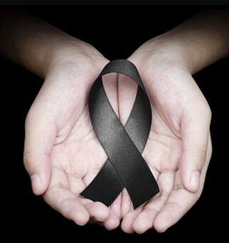 Manos sosteniendo un lazo negro contra el odio